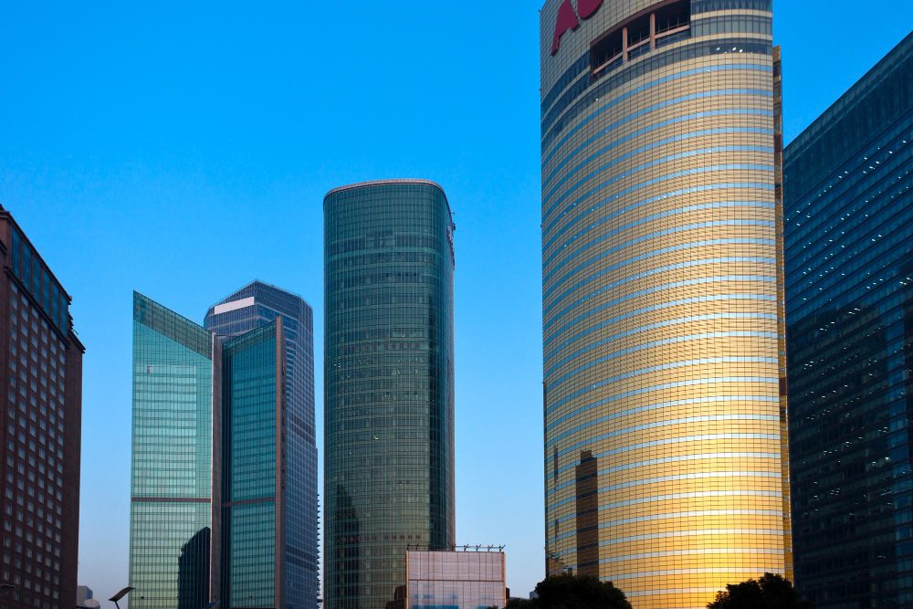 Modern skyscrapers and corporate buildings in Shanghai's Lujiazui financial district under a blue sky