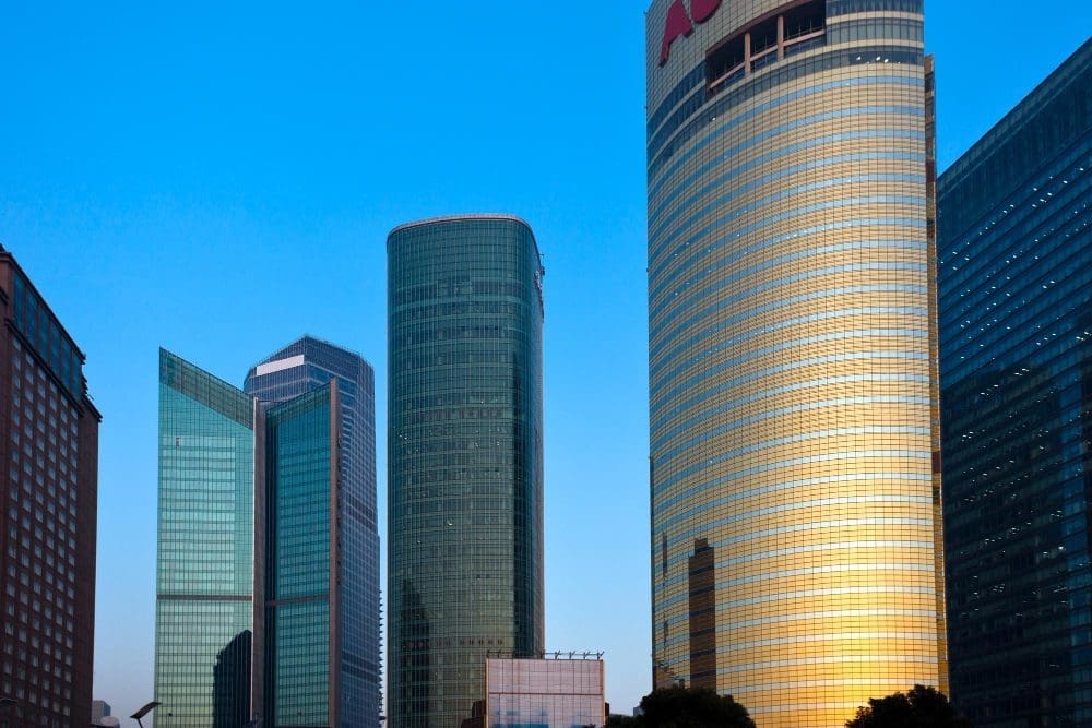 Modern skyscrapers and corporate buildings in Shanghai's Lujiazui financial district under a blue sky