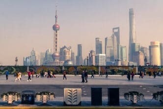 Shanghai skyline with the Oriental Pearl Tower and modern skyscrapers, with people walking in the foreground
