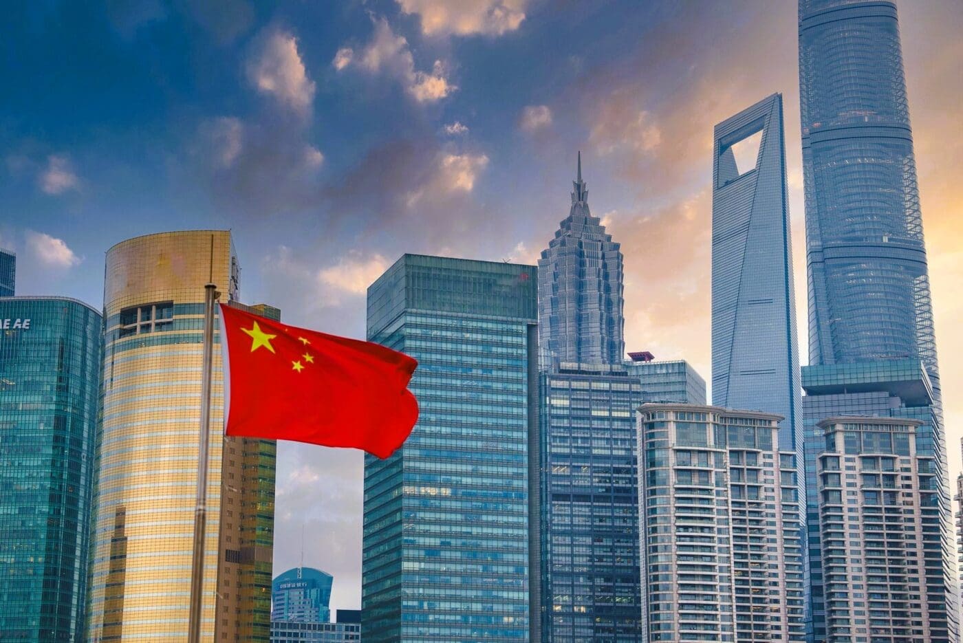 The Shanghai skyline with the Shanghai Tower and the Chinese flag prominently displayed