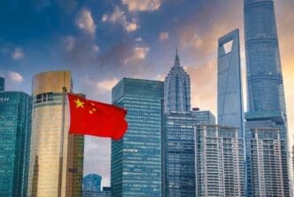 The Shanghai skyline with the Shanghai Tower and the Chinese flag prominently displayed
