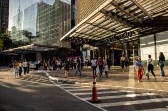 Shoppers and traffic near the entrance of Shopping Cidade Sao Paulo on Paulista Avenue