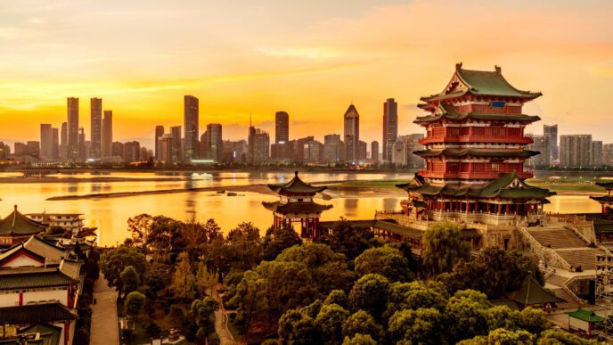 The Pavilion of Prince Teng and modern skyscrapers on the banks of a river at sunset