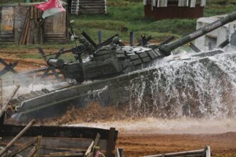 A Belarusian T-72 tank crossing a water obstacle during a demonstration drive, splashing water