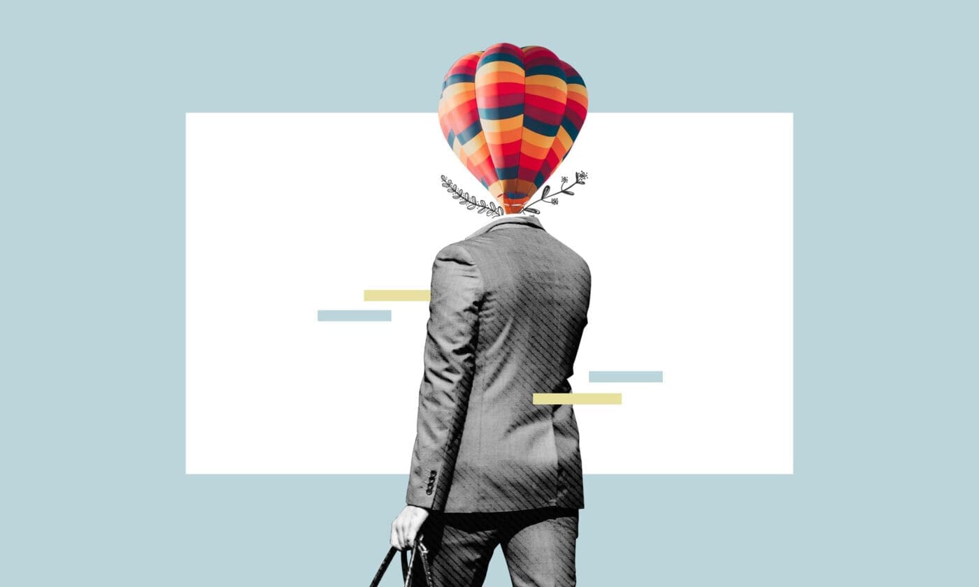 Surreal image of a person in a suit with a hot air balloon for a head