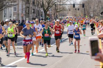 Runners of all ages and abilities participate in the Boston Marathon on a clear day