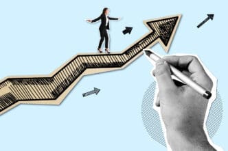 Businesswoman balancing on an upward graph line being drawn by a hand