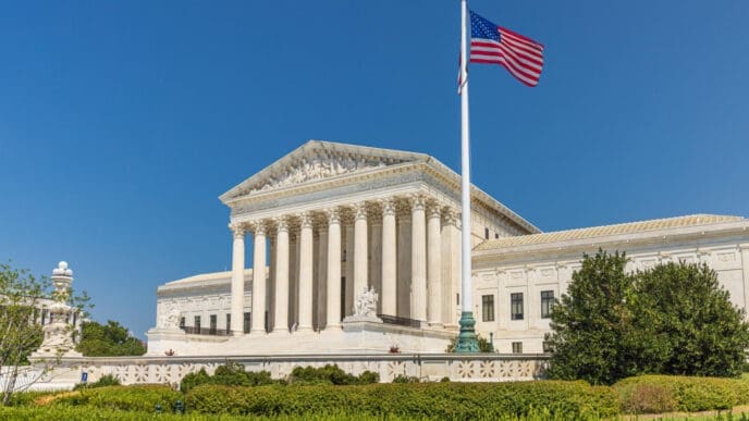 The United States Supreme Court building stands majestically with the American flag flying high in front of it