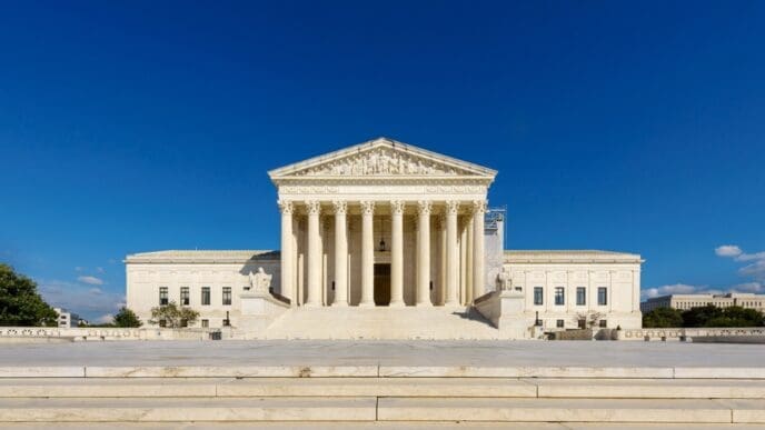 The majestic white marble Supreme Court building with its grand columns on a sunny day