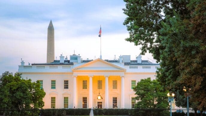 The White House and the Washington Monument are seen at dusk.