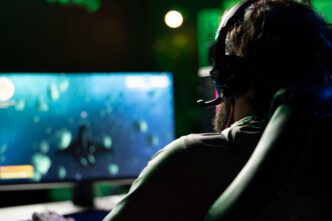 An esports player wearing a headset, looking at a computer screen during a video game