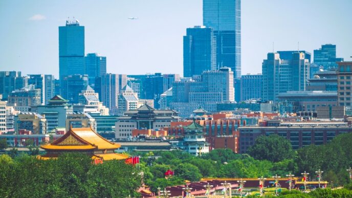 Tiananmen Gate, a traditional Chinese gate, stands in front of modern skyscrapers in Beijing