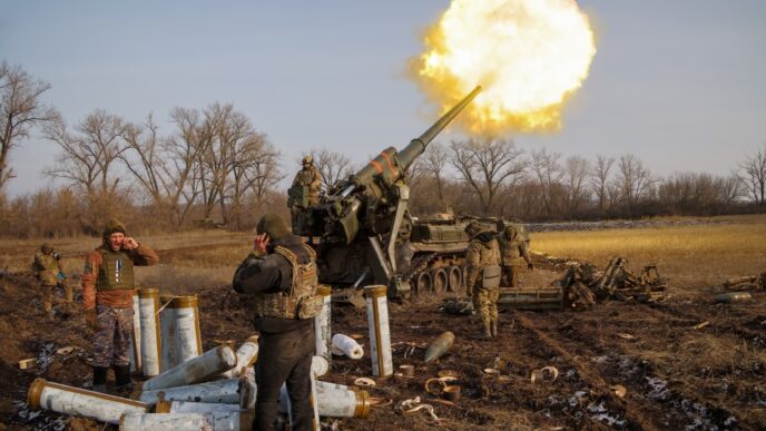 Ukrainian gunners fire a 2S7 Pion artillery cannon, creating a large flash of fire and smoke