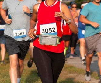 Runners with bib numbers participate in a race