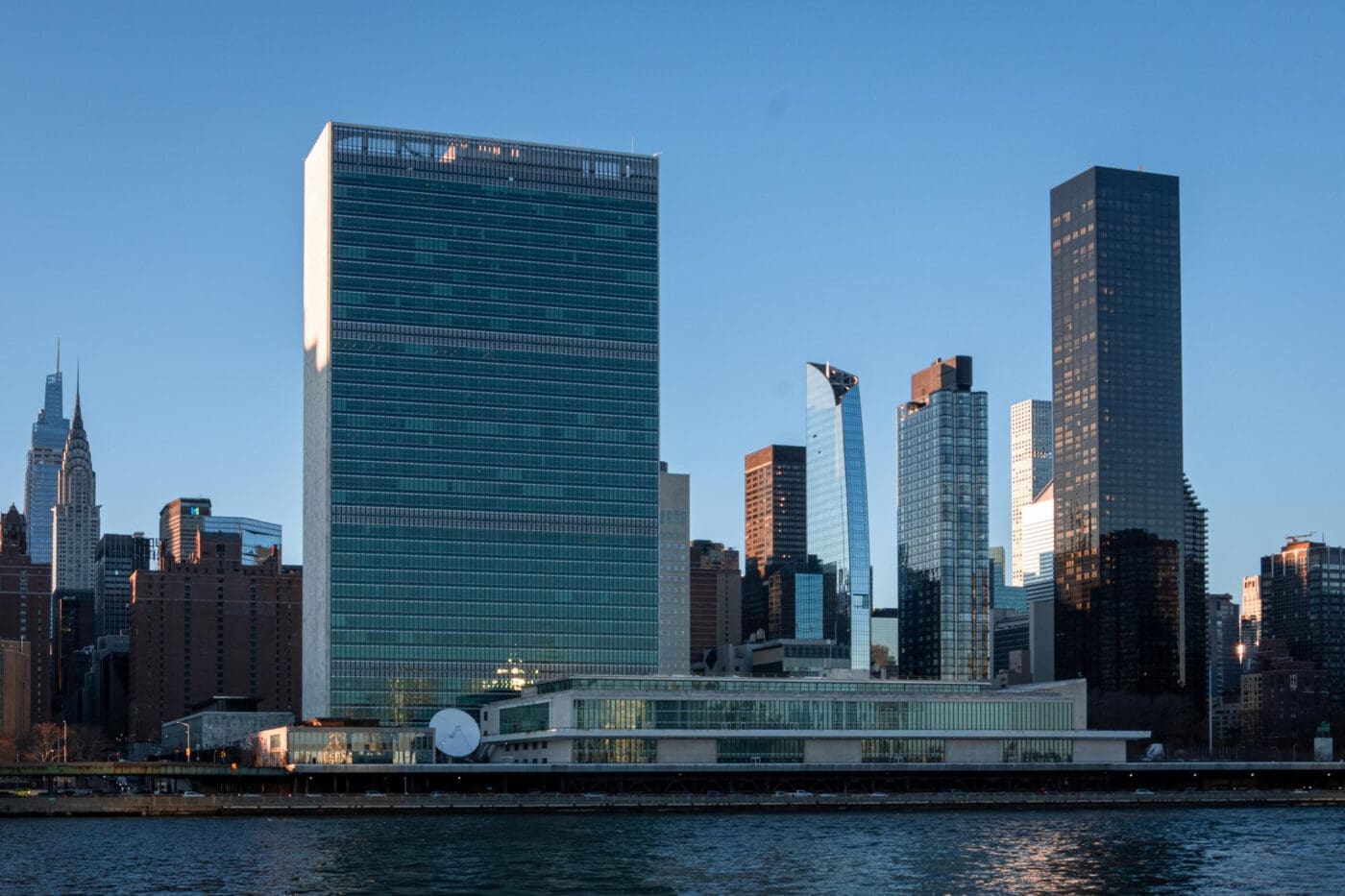 United Nations Headquarters building and surrounding skyscrapers on the East River in New York City