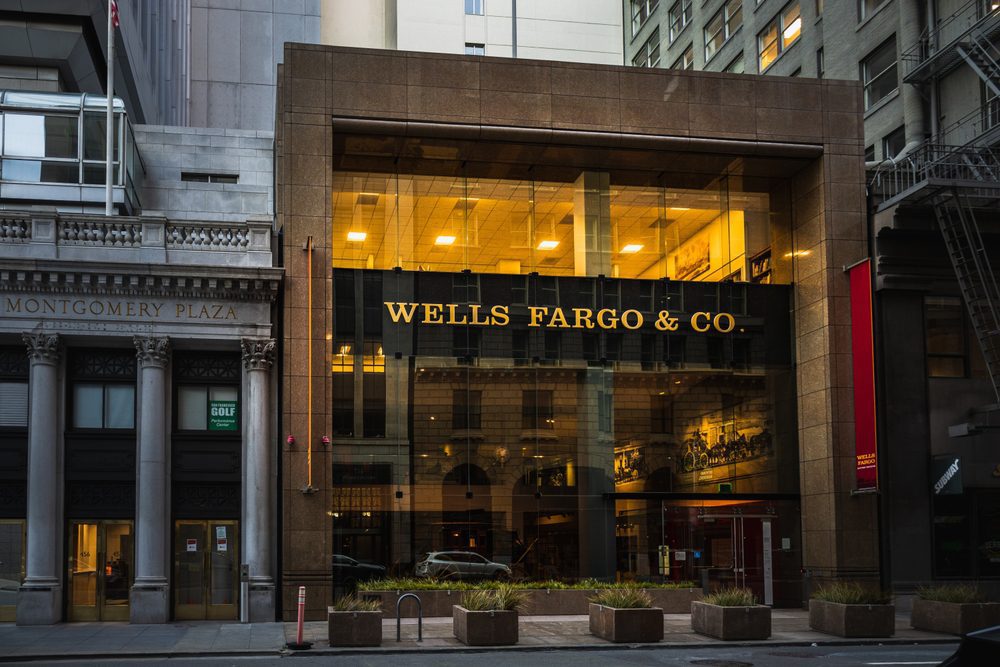The Wells Fargo & Co. building, with its illuminated interior and glass facade, in San Francisco's Financial District.
