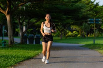 Woman running on a park path during golden hour
