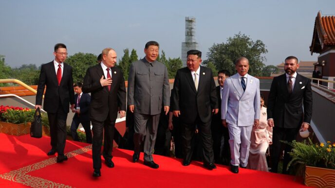 Chinese President Xi Jinping walking with other world leaders on a red carpet at a military parade