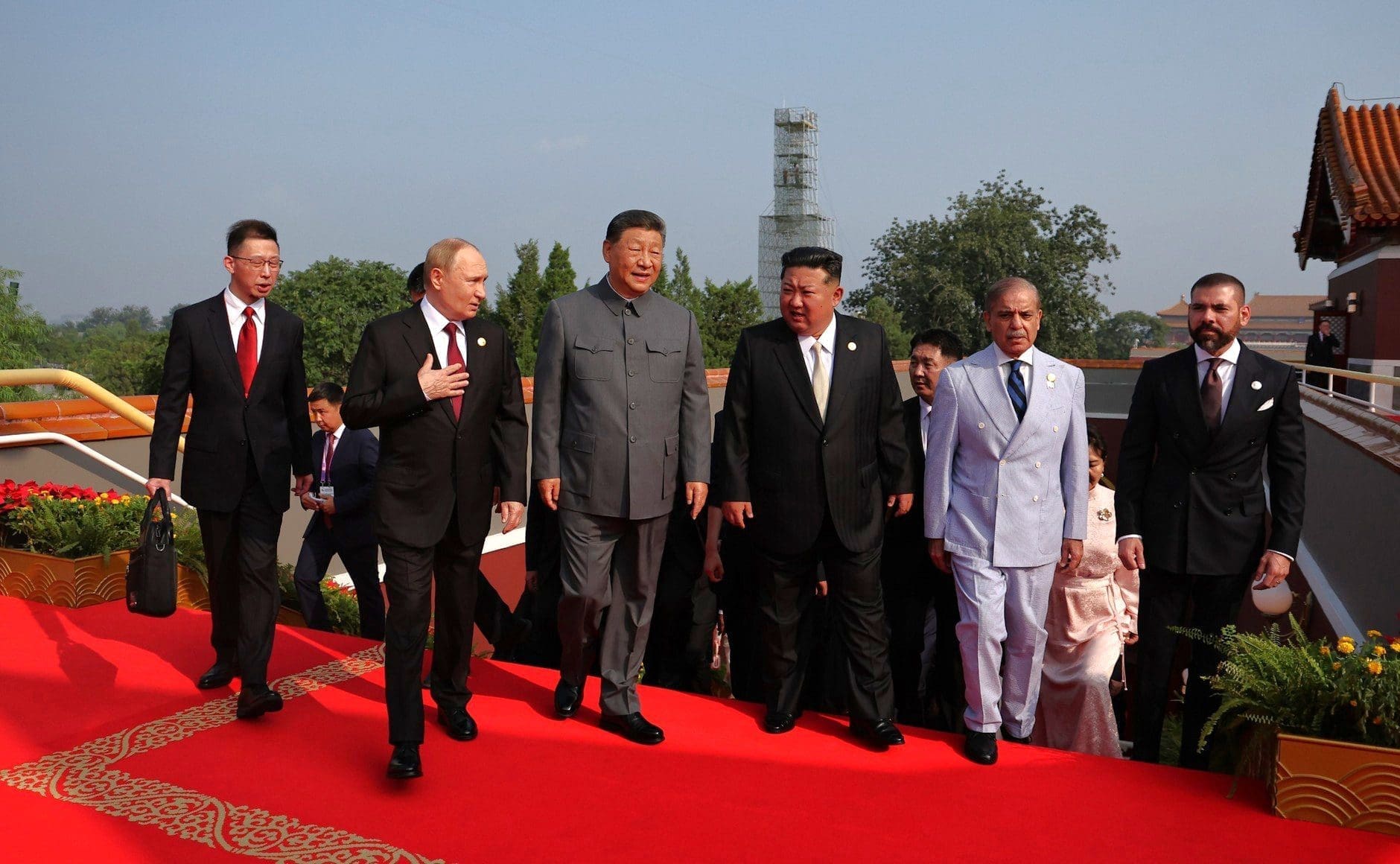 Chinese President Xi Jinping walking with other world leaders on a red carpet at a military parade