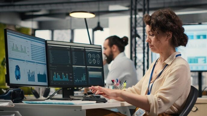 An administrator reviews financial data on a computer screen.