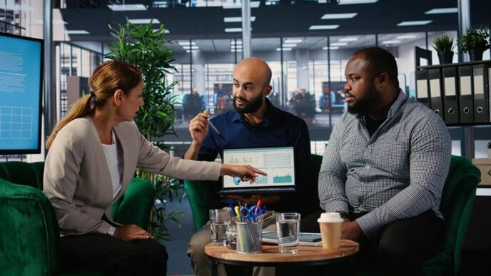 Business leaders collaborate around a table, focused on strategic planning.