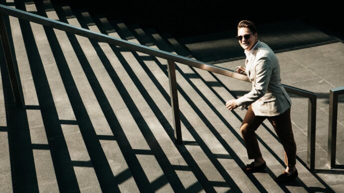 A young businessman climbs a flight of stairs, representing upward mobility.