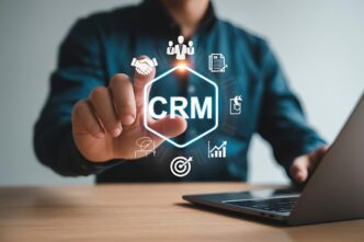 Business professional using a customer relationship management interface with icons for teamwork, sales, and analytics.
