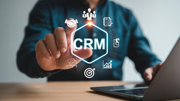Business professional using a customer relationship management interface with icons for teamwork, sales, and analytics.