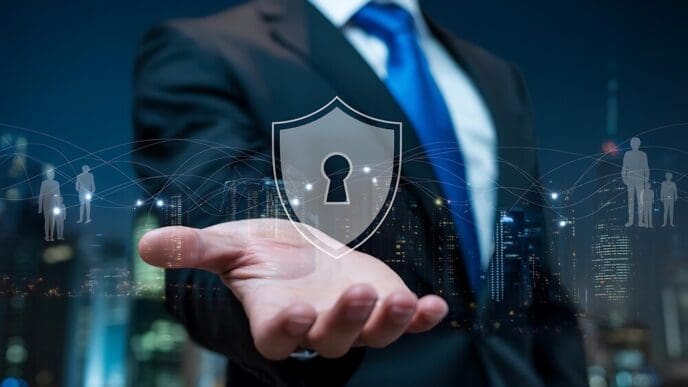A businessman in a blue suit holds a shield with a keyhole design and network connections superimposed over a city skyline.