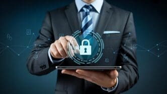 A businessman uses a tablet, illustrating concepts of cybersecurity and data protection.