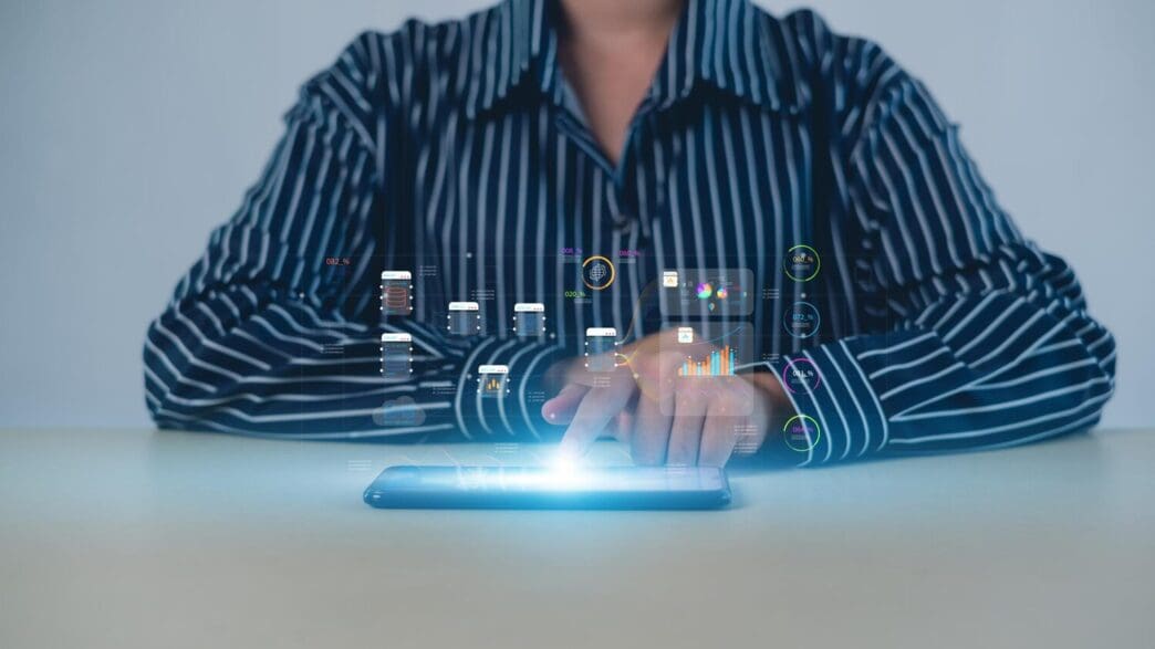 A person analyzes business metrics on a screen, likely as part of a digital transformation strategy.