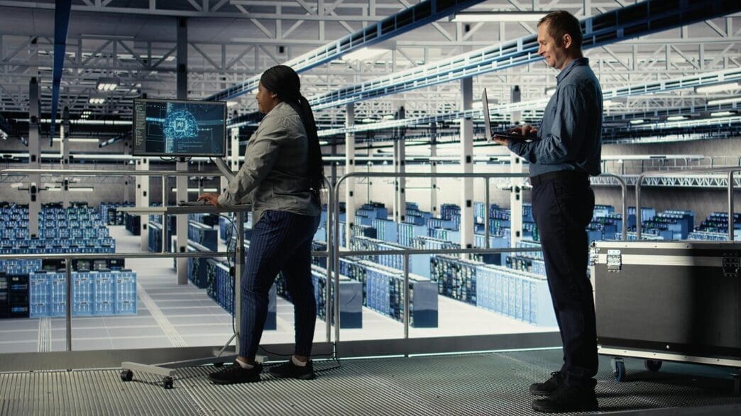 Software developers monitor deep learning processes on a computer screen in a data center.