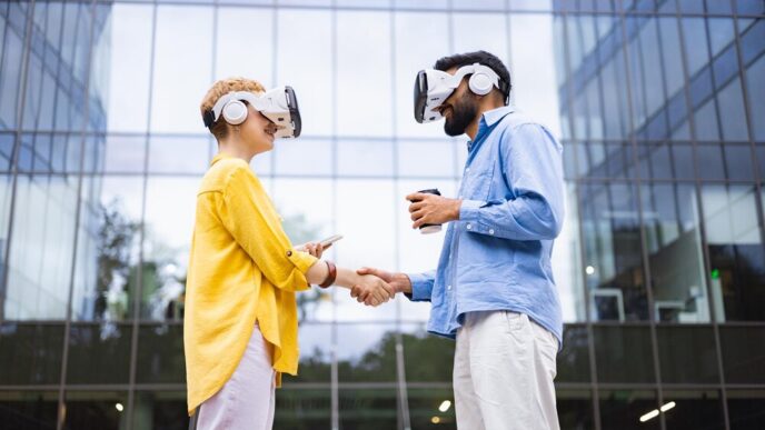 A diverse couple wearing virtual reality headsets shakes hands in front of a modern building, symbolizing technology.