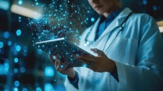 Doctor examining a computer screen displaying digital health data.