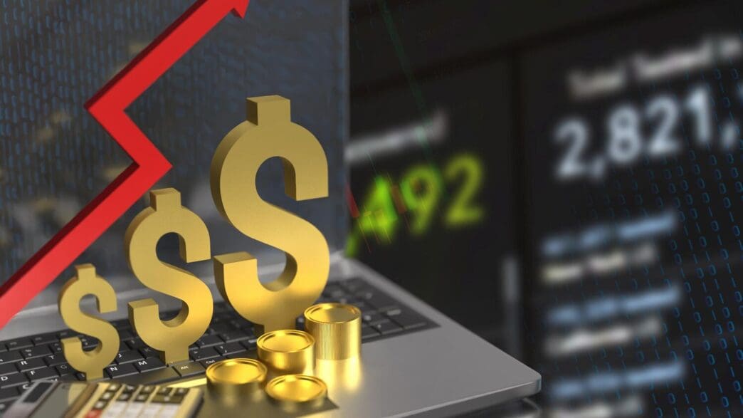 A gold dollar sign and upward-pointing arrow are displayed on a laptop screen, representing business growth.