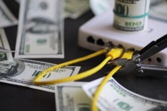 A router sits next to a stack of one hundred dollar bills, illustrating the cost of internet service.