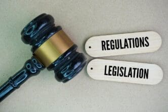 A gavel rests on a block next to the words "regulations" and "legislation," with the word "Legislation" partially visible.