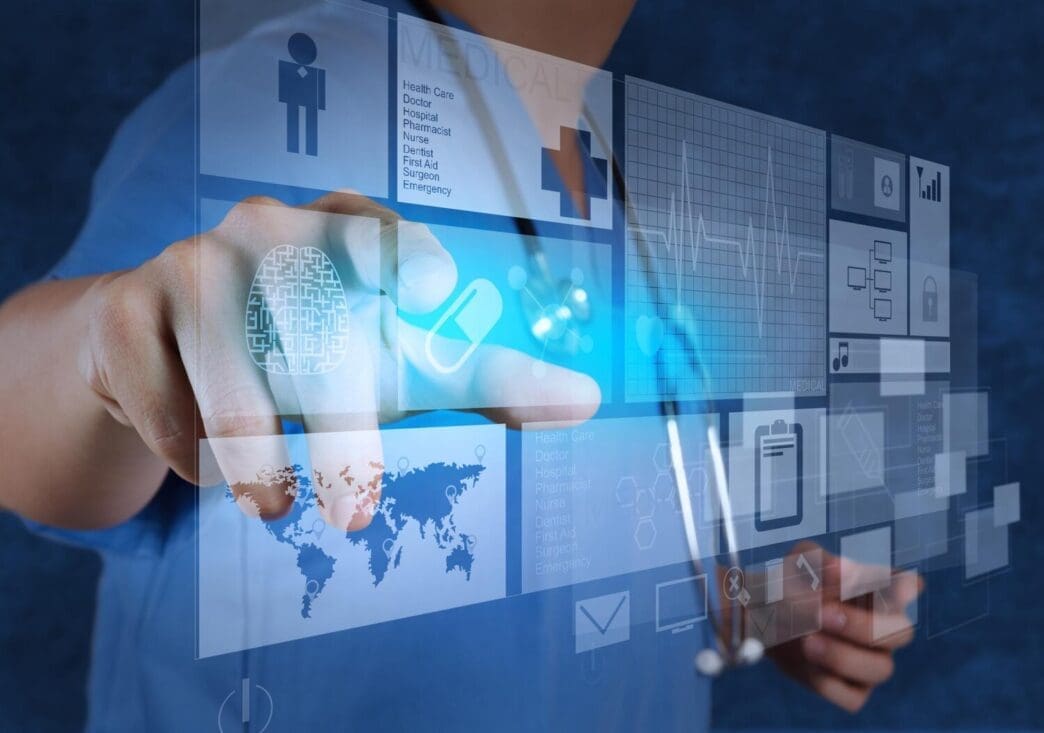 A doctor in a white coat uses a modern computer.