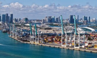 Aerial view of the Port of Miami, showing cargo containers and industrial infrastructure for import and export services.