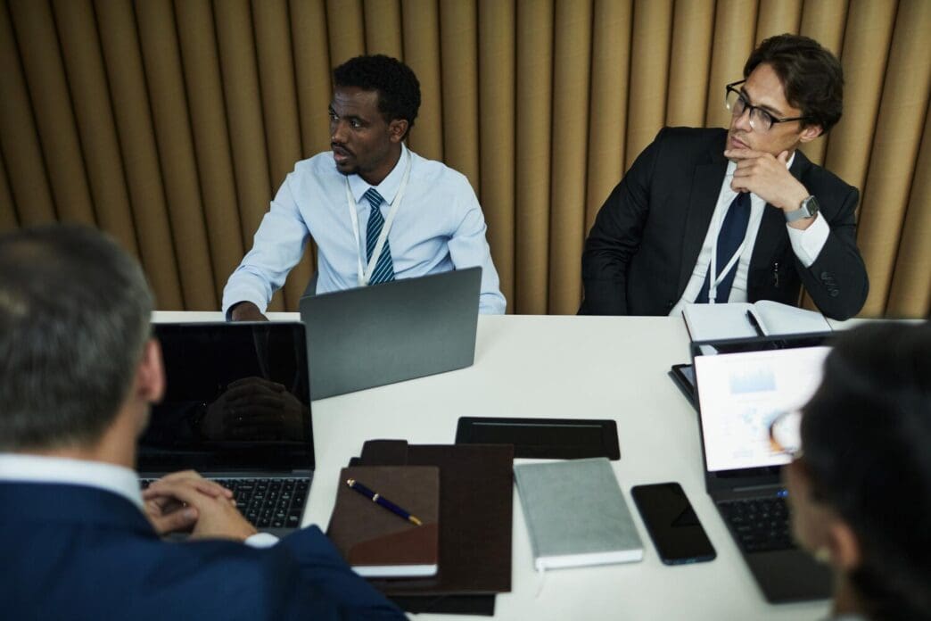 Multiethnic group of middle-aged business professionals attending a meeting.