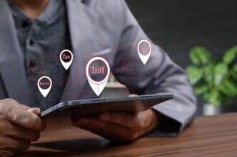 Person using a tablet displaying charts and text related to tax and duty.