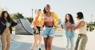 A group of friends in street wear breakdance with energy and rhythm in an urban park.