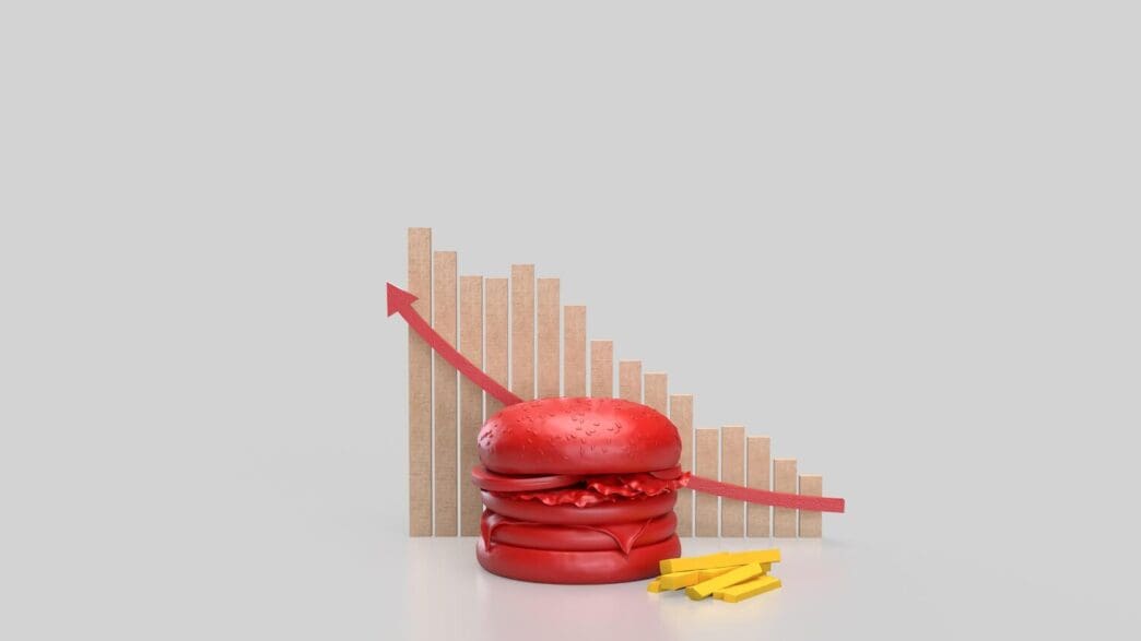 A 3D rendering depicts a vibrant red hamburger isolated against a clean white background, suggesting themes of food or health.