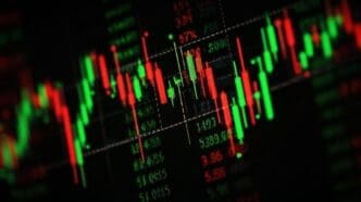 Candlestick chart illustrating stock market trends with red and green bars.