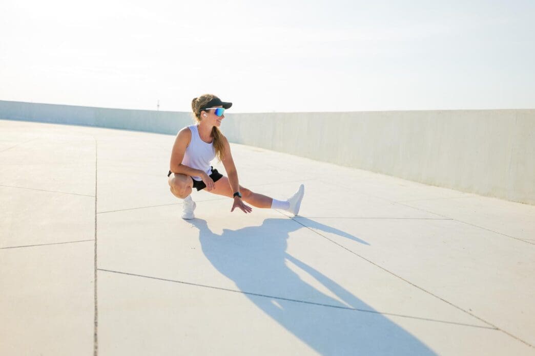 A person stretches on a smooth surface outdoors in the daytime.