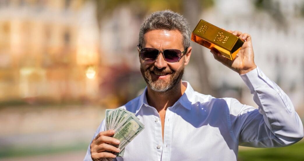 A wealthy businessman holds a gold bar and stacks of cash, illustrating financial success.
