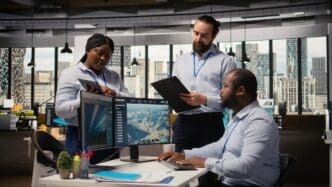 Engineers in an office collaborate while testing green energy production technology.