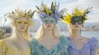 Three women wearing masks and floral headdresses.