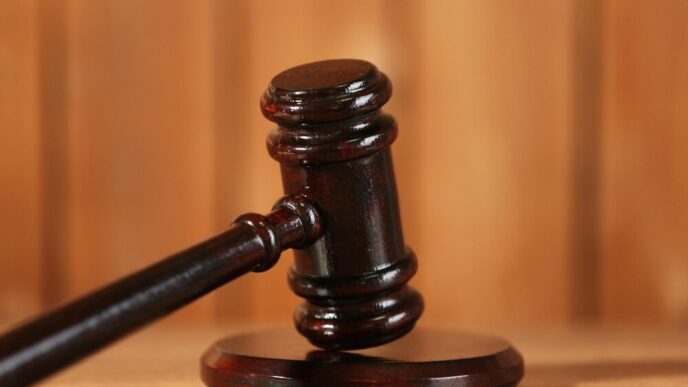 Close-up of a wooden judge's gavel on a wooden table.