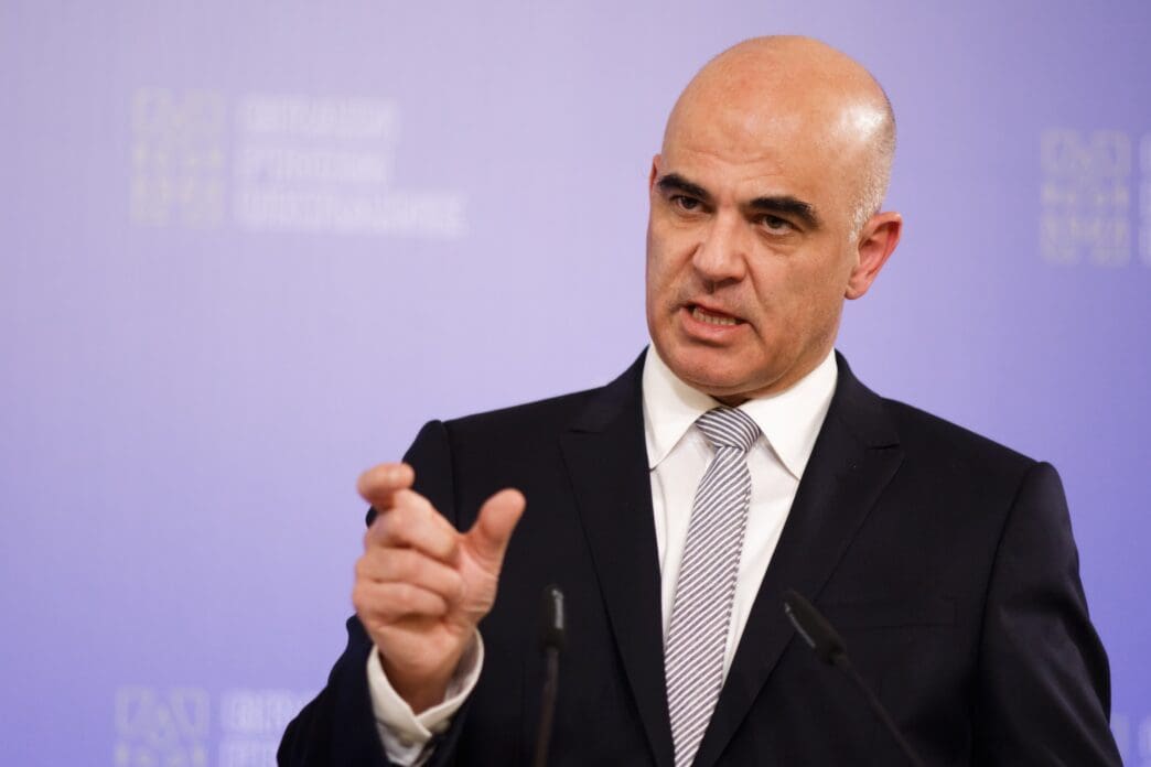 Alain Berset speaks at a press conference with microphones in front of him